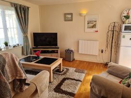 A living room with a television and coffee table at Riverside cottage near Tintagel in Camelford