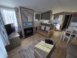 A living room with a television and fireplace at Beach holiday base with pool and kids activities