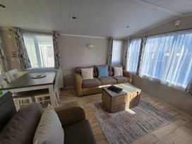 A living room with a sofa and table at Beach holiday base with pool and kids' activities