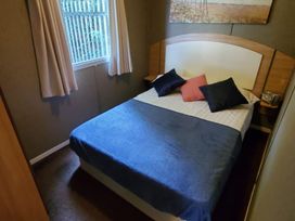 A bedroom with a bed and pillows at tbc in 