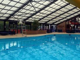 An indoor pool area with a lifeguard chair and cafe at tbc 