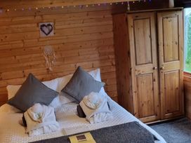 A bedroom with a bed and wardrobe at tbc