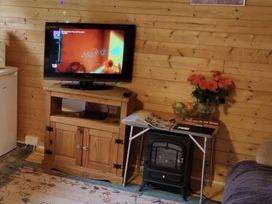 A living room with a television and a coffee table at tbc in 