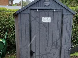 A shed with a sign that says Shower Room at tbc 