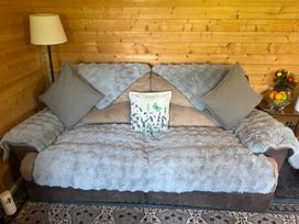 A sofa with pillows and decorative cushion in a snug at tbc