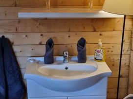A sink with towels and soap in a bathroom at tbc