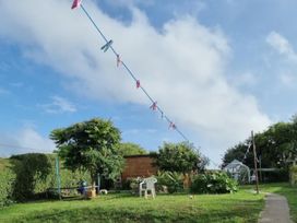 A garden with a clothesline and a chair at tbc 