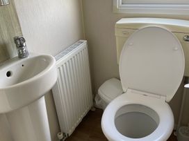 A bathroom with a sink and toilet at tbc 