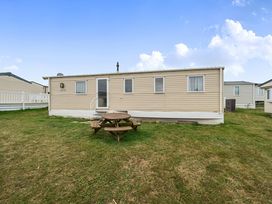 A caravan with a picnic table outside at Pet-friendly lodge near Fistral Beach, Fistral Beach, Newquay