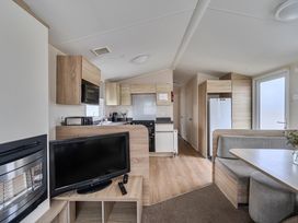 A kitchen and dining area with a television at Pet-friendly lodge near Fistral Beach, Fistral Beach, Newquay