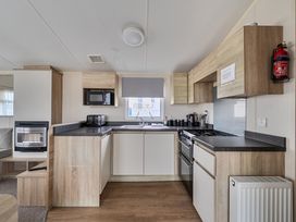 A kitchen with appliances and a sink at Pet-friendly lodge near Fistral Beach, Fistral Beach, Newquay