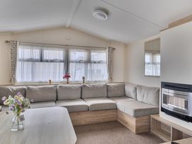 A living room with a grey sofa and a table at Pet-friendly lodge near Fistral Beach, Fistral Beach, Newquay