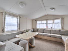 A living room with a table and couch at Pet-friendly lodge near Fistral Beach, Fistral Beach, Newquay