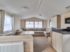 A living room with a sofa and table at Pet-friendly lodge near Fistral Beach, Fistral Beach, Newquay