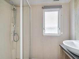A bathroom with a shower and sink at Pet-friendly lodge near Fistral Beach, Fistral Beach, Newquay