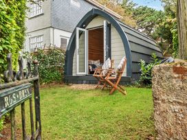 A garden with a pod structure and chairs at Peaceful pod with bay views, walk to 3 beaches St Ives
