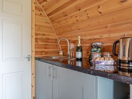 A kitchen area with a sink and a kettle at Peaceful pod with bay views, walk to 3 beaches St Ives