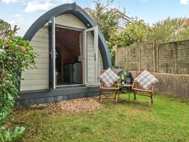 A garden with an outdoor pod and chairs at Peaceful pod with bay views, walk to 3 beaches St Ives