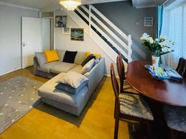 A living room with a sofa and dining table at tbc