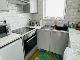 A kitchen with a sink, oven, and microwave at tbc 