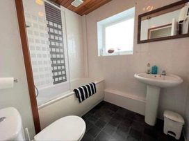 A bathroom with a bathtub, sink and toilet at tbc