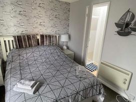 A bedroom with a bed and a lamp at tbc 