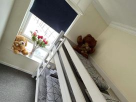 A bedroom with a bunk bed and stuffed animals at tbc