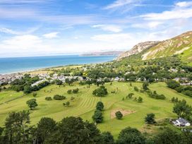 An outdoor view featuring hills, sea, and grassland at tbc 