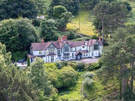A house with garden and trees at tbc 