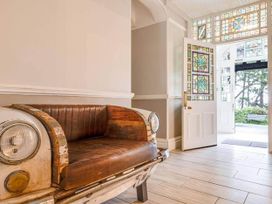An entrance with a bench and stained glass windows at tbc
