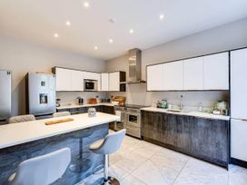 A kitchen with appliances and seating at tbc