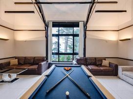 A game room with a pool table and sofas at tbc in 