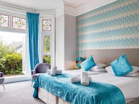 A bedroom with two beds and a window at tbc