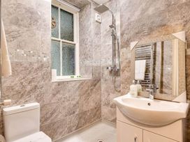 A bathroom with a shower, sink, and toilet at tbc