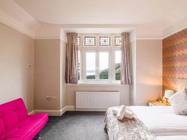 A bedroom with a bed and a sofa at tbc in 