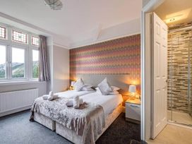 A bedroom with a bed and an en-suite bathroom at tbc 