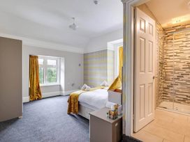 A bedroom with a bed and shower at The Old Barn in Manchester