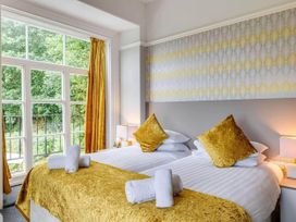 A bedroom with two beds and large windows at tbc in 