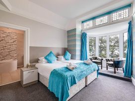 A bedroom with two beds and a seating area at tbc in 