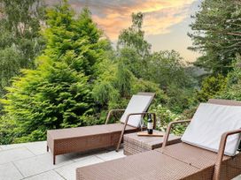 A garden with sun loungers and a table at tbc 