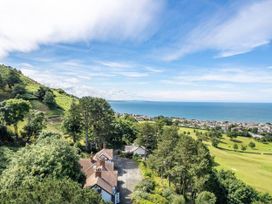 A view of trees and ocean from a hilltop at tbc 