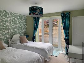 A bedroom with two single beds and a desk at tbc in 