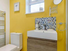 A bathroom with yellow walls and fixtures at tbc 