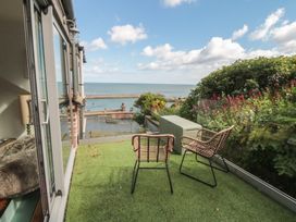 A balcony with chairs and a table overlooking the sea at Hillsover in Saltburn-by-the-Sea
