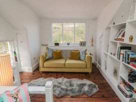 A living room with a sofa and shelves at Hillsover in Saltburn-by-the-Sea