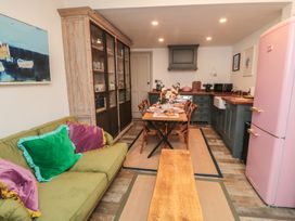 A kitchen with a dining table and pink fridge at Hillsover in Saltburn-by-the-Sea