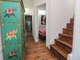 A hallway with a wardrobe and staircase at Hillsover in Saltburn-by-the-Sea