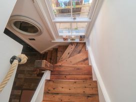 A staircase with wooden steps and a mirror at Hillsover in Saltburn-by-the-Sea