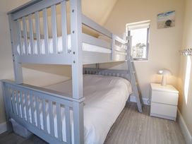 A bedroom with a bunk bed and a nightstand at Cabin 4 Doire Chonair in Gortahawk