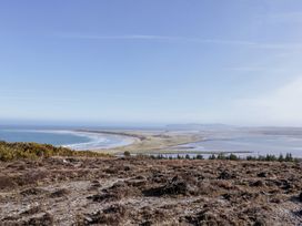 A landscape view overlooking the coastline and grassland at Cabin 5 Eargail in Gortahawk